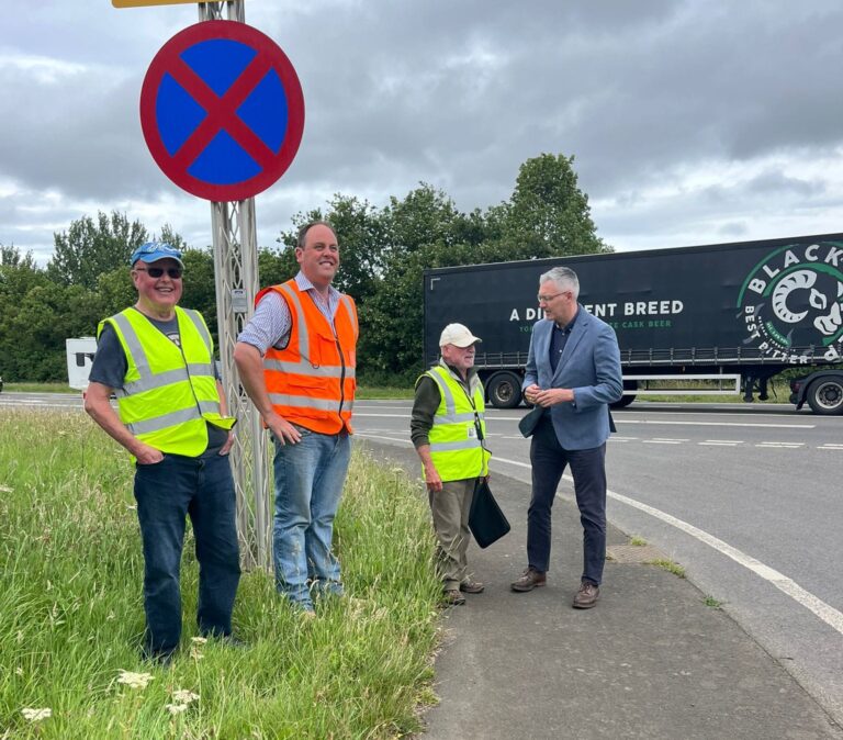 David speaking with residents next to a busy A1 junction